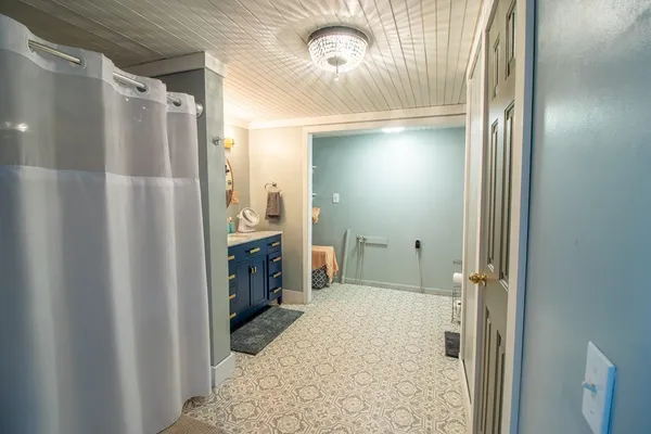 a bathroom with a shower and a sink