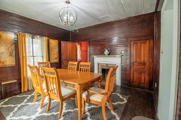 a dining room with furniture a chandelier and window