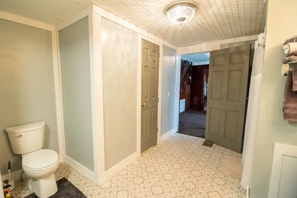 a bathroom with a toilet and a shower