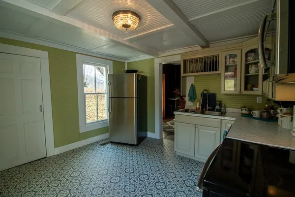 a kitchen with a refrigerator and a sink
