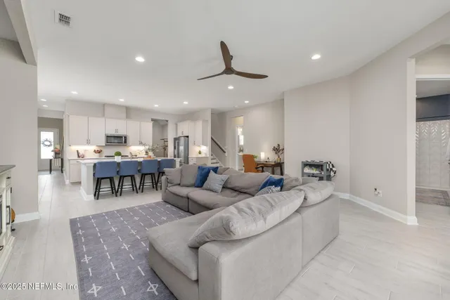 a bedroom with a bed and large windows