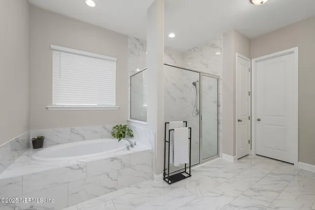 a bathroom with a double vanity sink toilet and shower