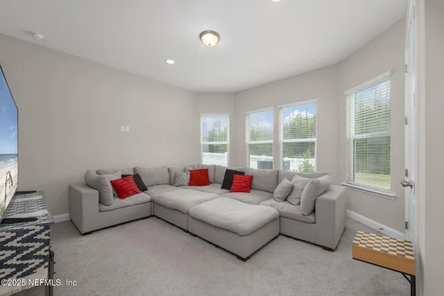 a view of a workspace with furniture and stairs