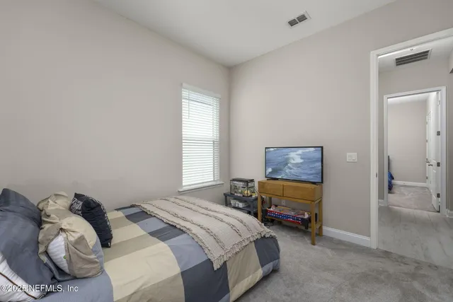 a living room with furniture a piano and a potted plant
