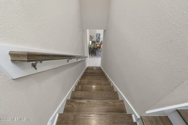 a room with furniture pool table and chairs