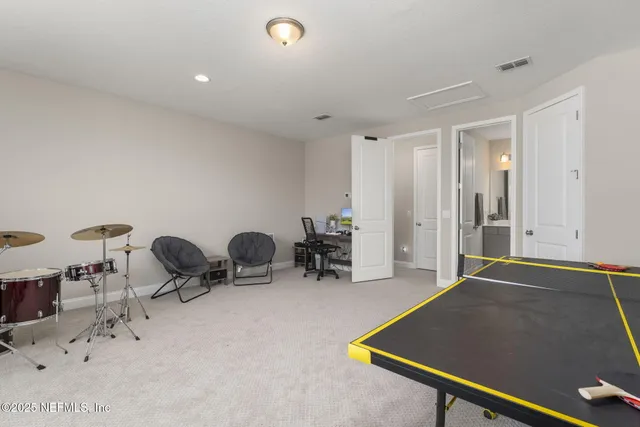 a bathroom with a toilet sink vanity and mirror
