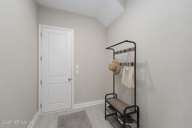 a balcony with couple of chairs and a large window