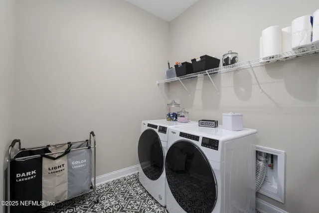 a living room with furniture floor to ceiling window and an outdoor view