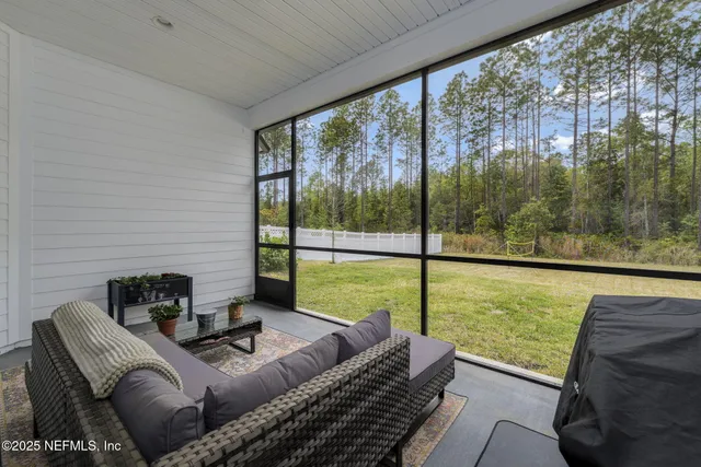 an aerial view of a house with a yard and a large tree