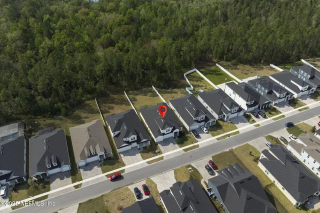 an aerial view of a house with outdoor space