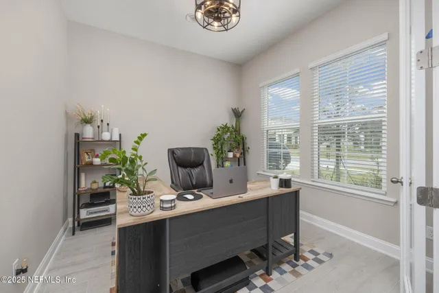 a view of a dining room with furniture and window