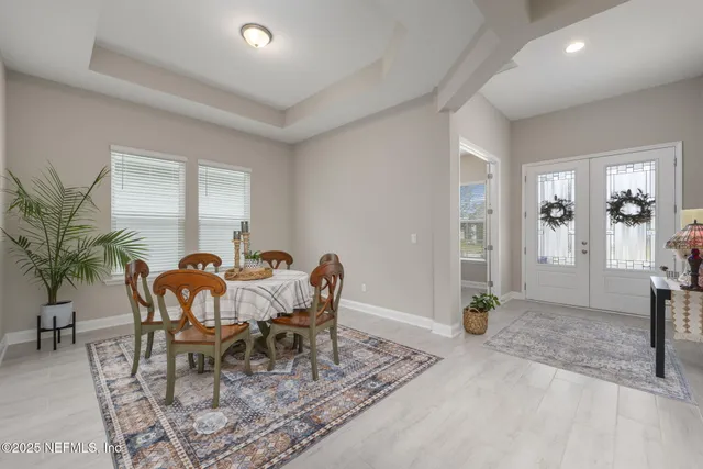 a kitchen with a sink a refrigerator a stove a washer dryer and a dining table