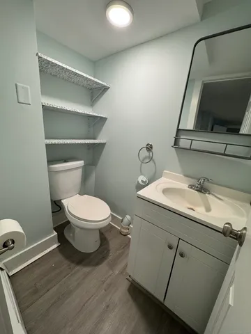 a bathroom with a toilet sink and mirror