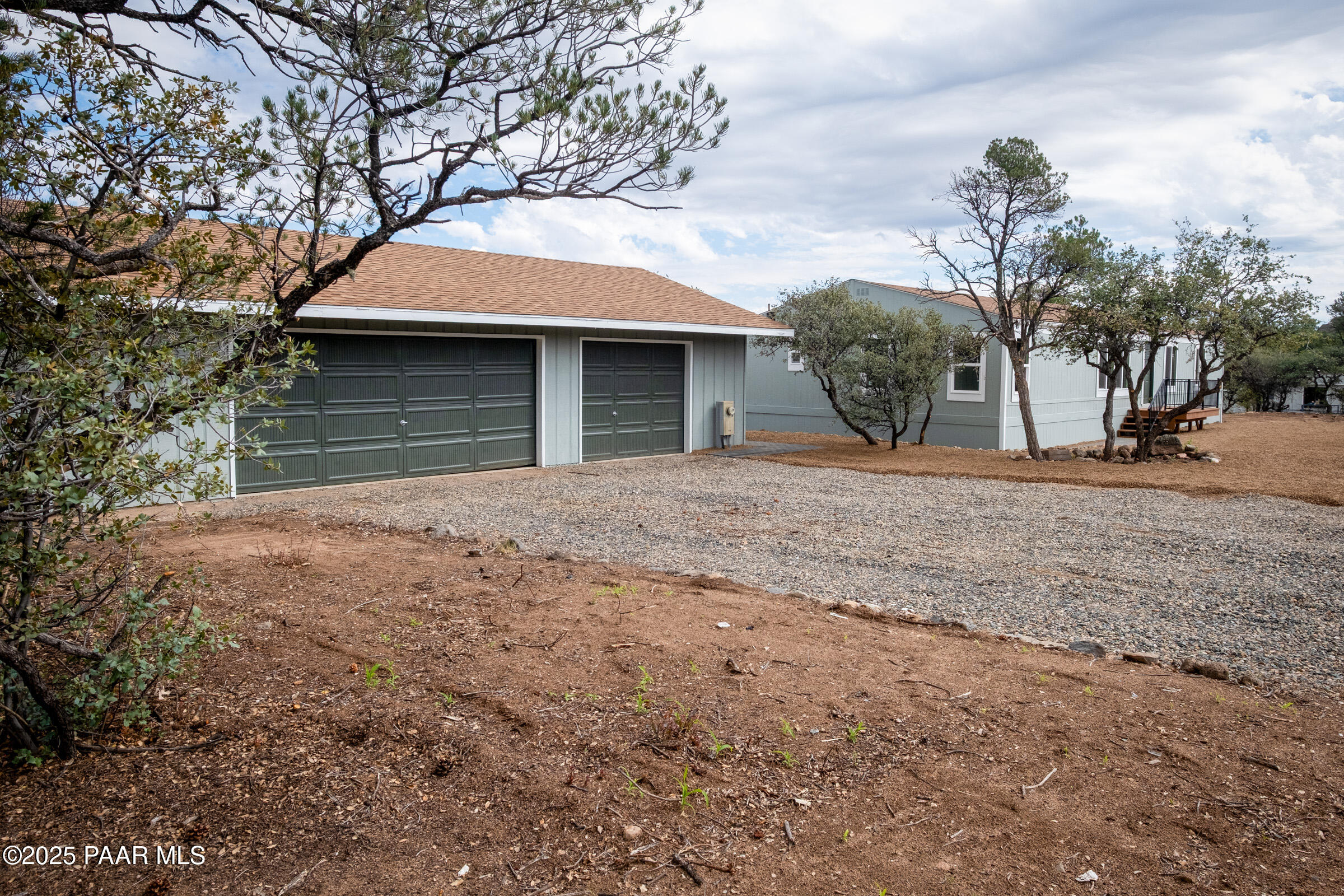 6635 North Double Tree Road Prescott, AZ 86305 - Photo 4 of 69 a front view of a house with a yard and garage