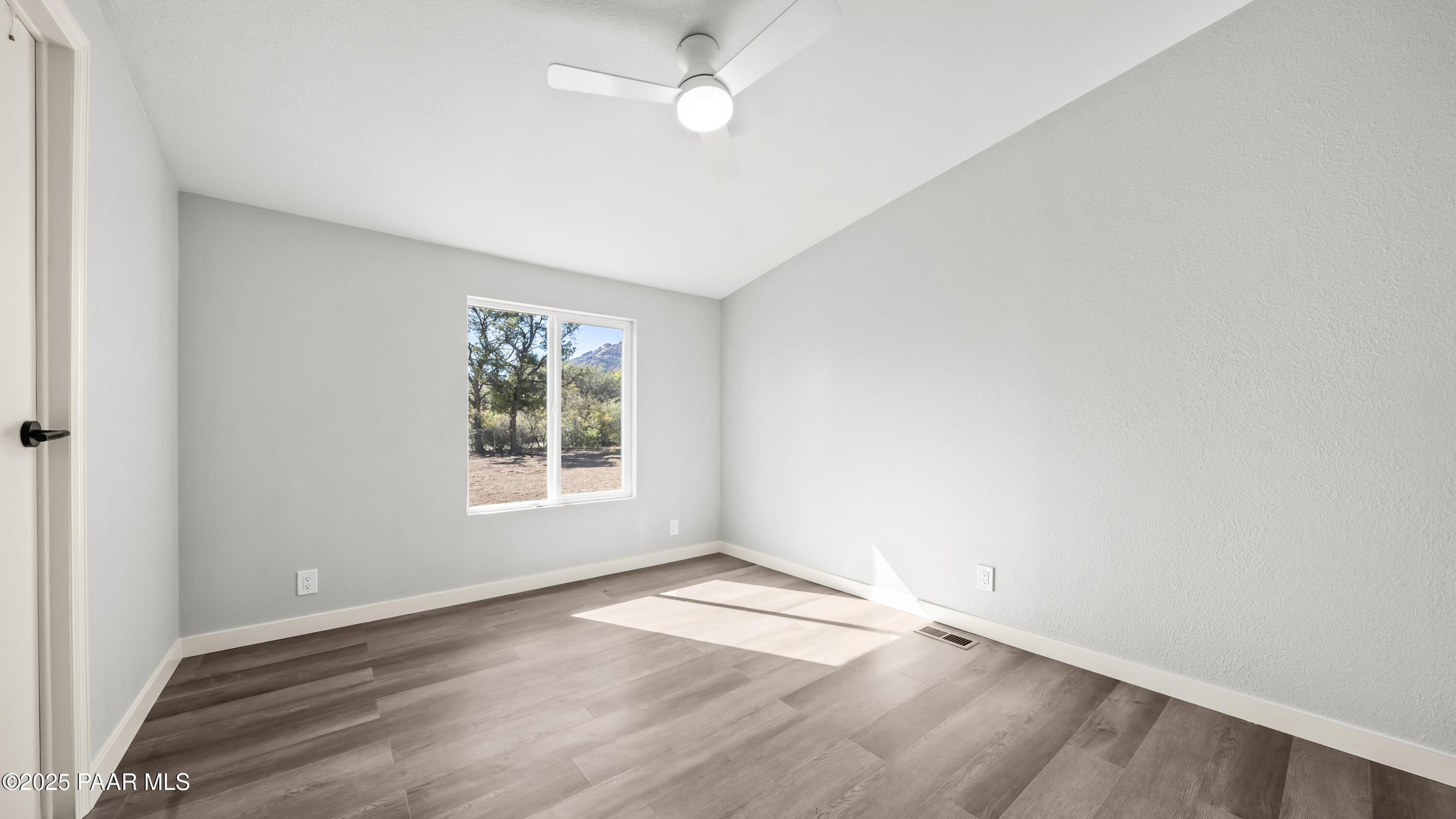 6635 North Double Tree Road Prescott, AZ 86305 - Photo 52 of 69 an empty room with wooden floor and windows