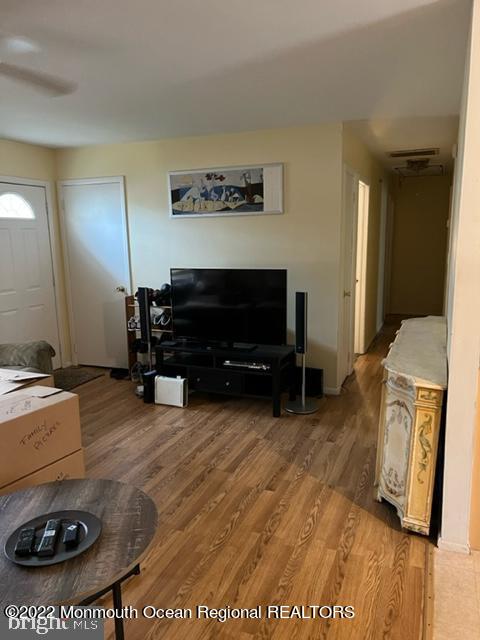 282 Privateer Road Manahawkin, NJ 08050 - Photo 11 of 18 a living room with furniture and a flat screen tv