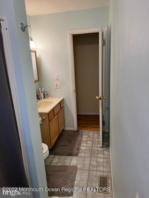 282 Privateer Road Manahawkin, NJ 08050 - Photo 12 of 18 a bathroom with a sink a toilet and mirror