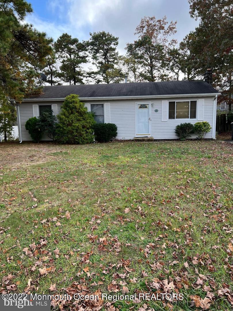 282 Privateer Road Manahawkin, NJ 08050 - Photo 2 of 18 a front view of house with yard and trees in the background