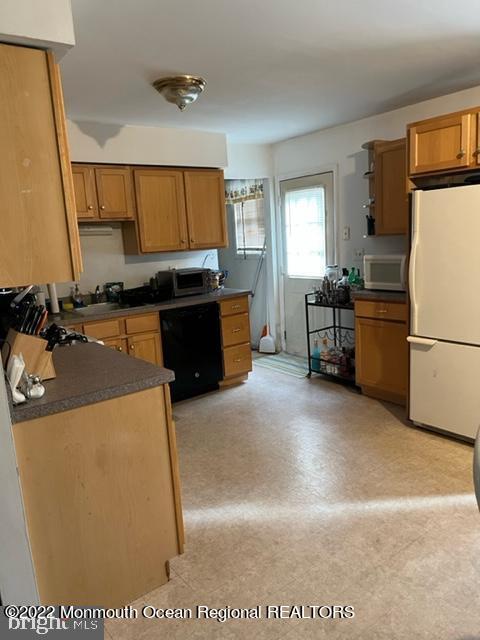 282 Privateer Road Manahawkin, NJ 08050 - Photo 3 of 18 a kitchen with a refrigerator and a stove