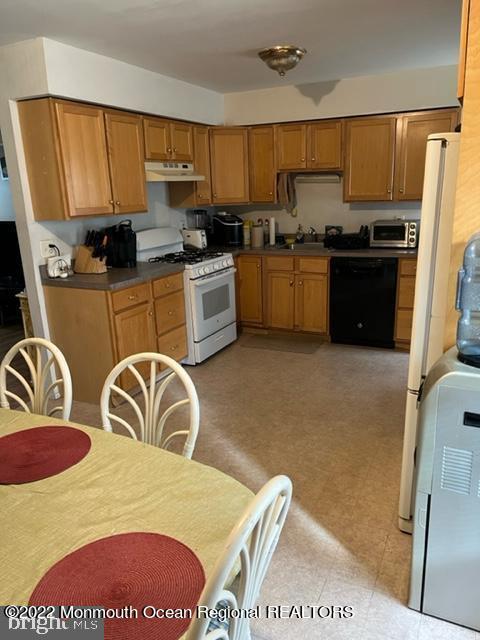 282 Privateer Road Manahawkin, NJ 08050 - Photo 4 of 18 a kitchen with stainless steel appliances granite countertop a sink a stove a refrigerator a counter space and cabinets
