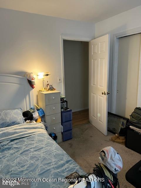 282 Privateer Road Manahawkin, NJ 08050 - Photo 6 of 18 a bed room with a bed and a dresser