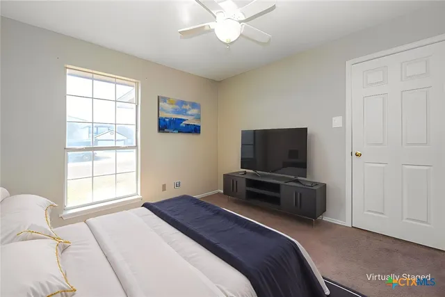 a bedroom with a bed and a television