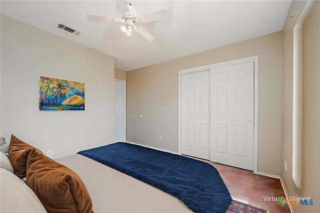 a bedroom with a bed and a painting on the wall