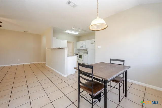 a view of kitchen and dining area with chandelier