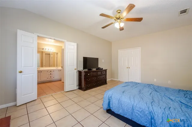 a bedroom with a bed and a flat screen tv