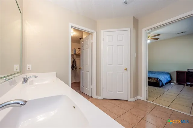 a spacious bathroom with a tub shower and a sink