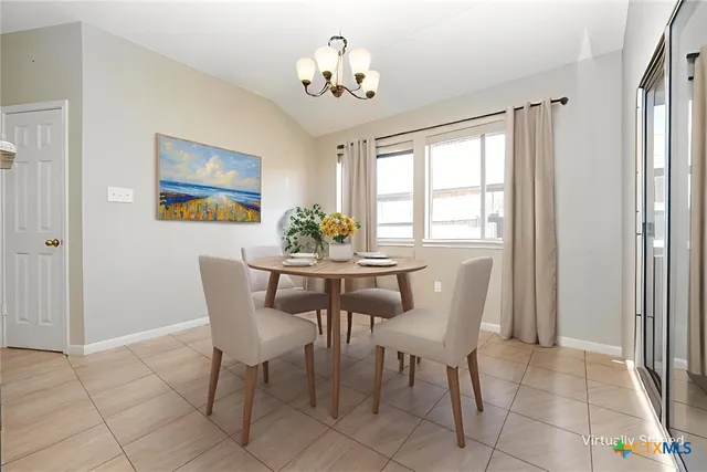 a dining room with furniture and window