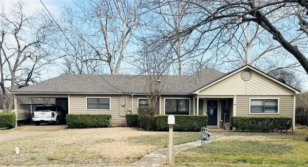 a front view of a house with a yard covered in snow