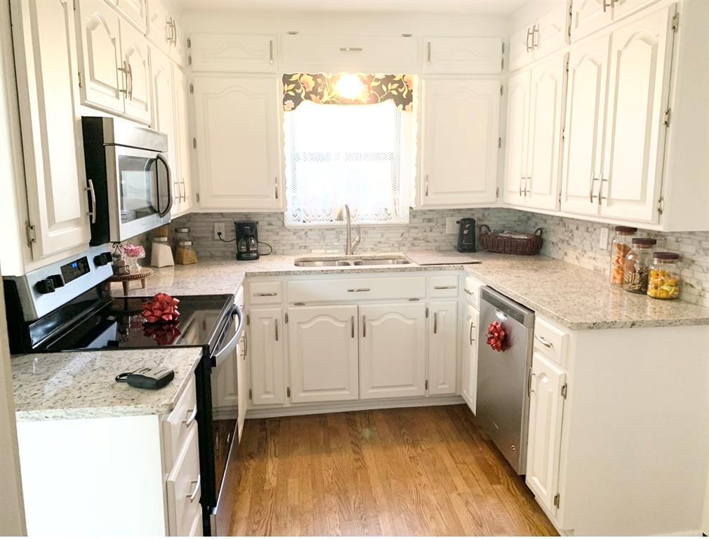 429 South Broadway Street Bells, TX 75414 - Photo 6 of 10 a kitchen with a sink a stove and cabinets
