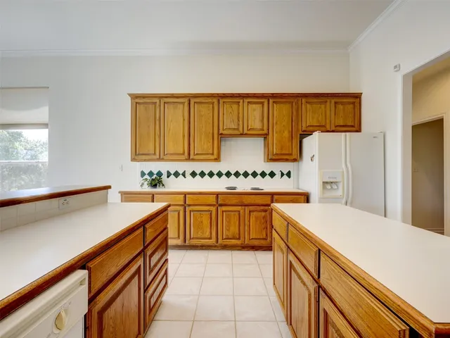 a kitchen with stainless steel appliances granite countertop a sink and cabinets