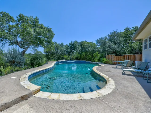 a view of a swimming pool with a patio
