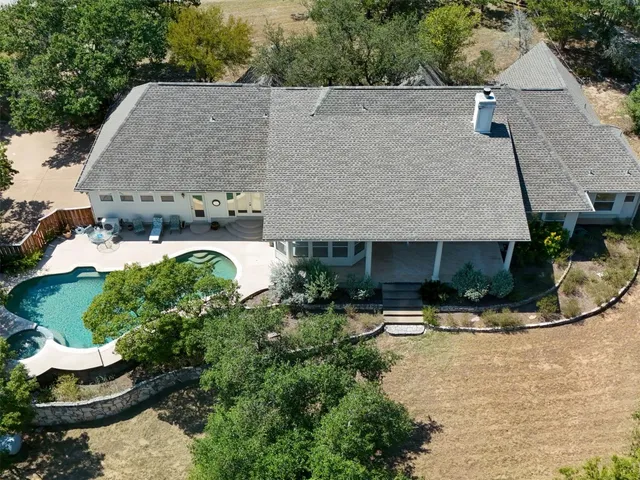 an aerial view of a house with yard swimming pool and outdoor seating