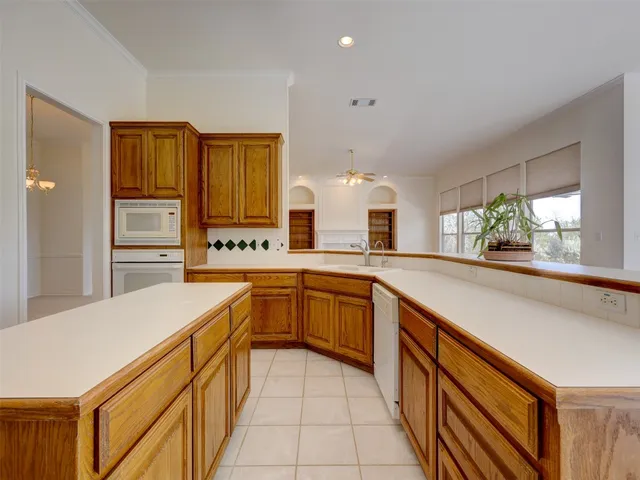 a kitchen with stainless steel appliances granite countertop a sink and cabinets