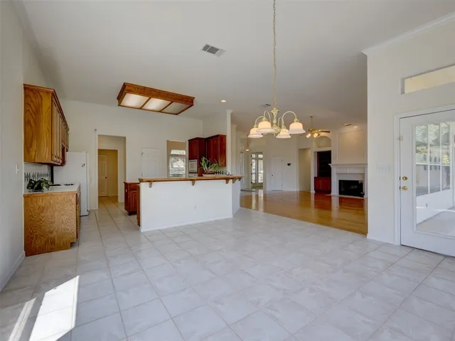 a view of a kitchen with kitchen island stainless steel appliances microwave and cabinets