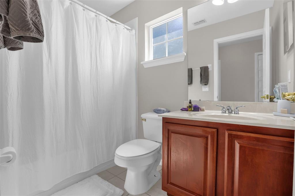 2165 Ridgewood Street Orlando, FL 32803 - Photo 23 of 37 a bathroom with a toilet a sink and a mirror