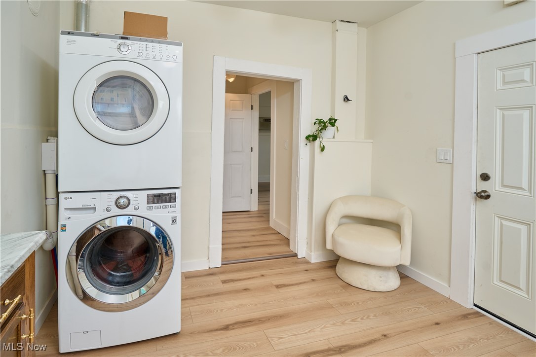 5432 State Road Parma, OH 44134 - Photo 20 of 47 Laundry area featuring light wood-style floors and stacked washing machine and dryer