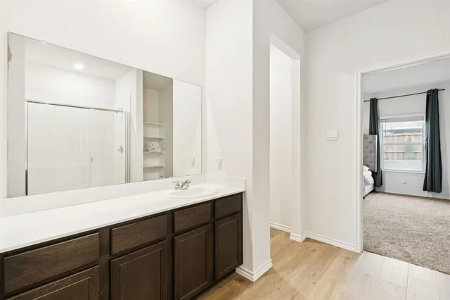 a bathroom with a double vanity sink and a mirror