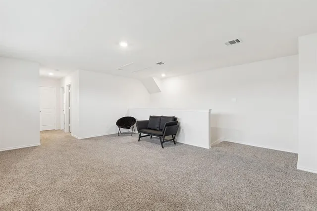 a view of an empty room with a bench