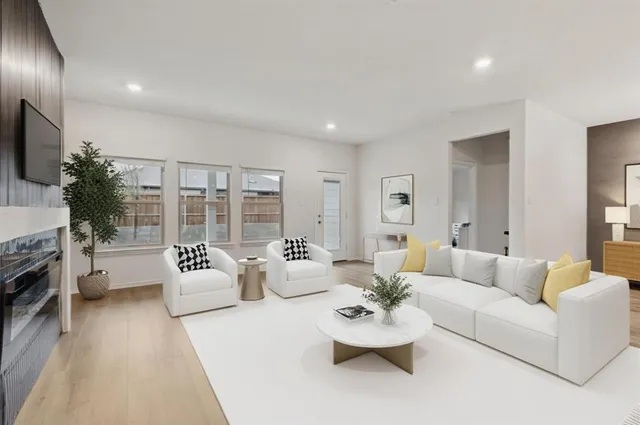 a living room with fireplace furniture and a flat screen tv