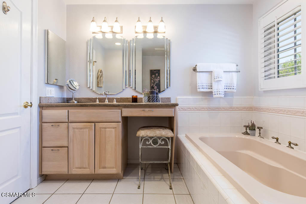 1161 Rambling Road Simi Valley, CA 93065 - Photo 14 of 48 a spacious bathroom with a bathtub sink and double vanity