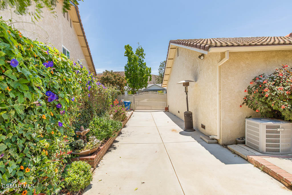 1161 Rambling Road Simi Valley, CA 93065 - Photo 29 of 48 a path view of a house with a yard and fountain in the background