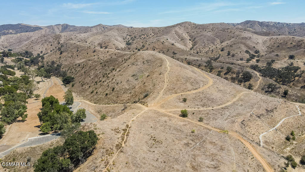 1161 Rambling Road Simi Valley, CA 93065 - Photo 45 of 48 a view of a dry yard with mountains in the background