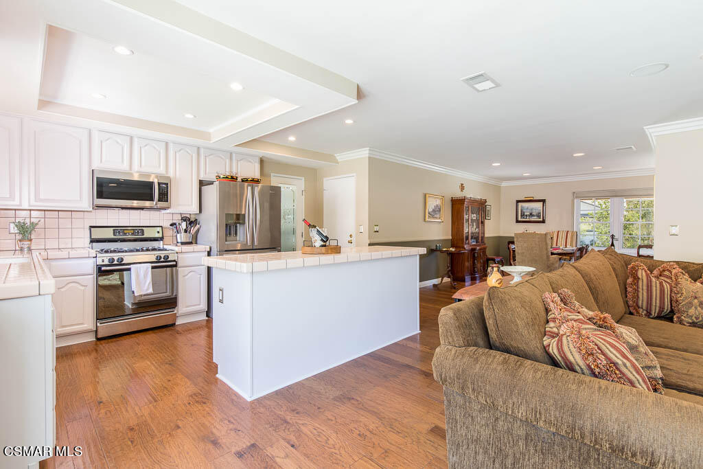 1161 Rambling Road Simi Valley, CA 93065 - Photo 7 of 48 a living room with stainless steel appliances furniture and a view of kitchen