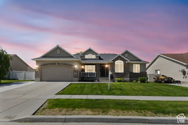 5489 Hampton Way Tooele, UT 84074 - Photo 1 of 1 View of front of home featuring driveway, covered porch, and a garage
