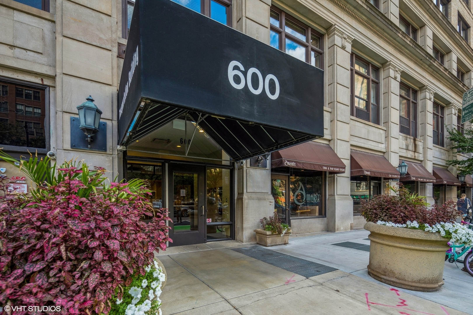 600 South Dearborn Street, Unit 1104 Chicago, IL 60605 - Photo 2 of 10 a front view of a building with lots of flowers and trees