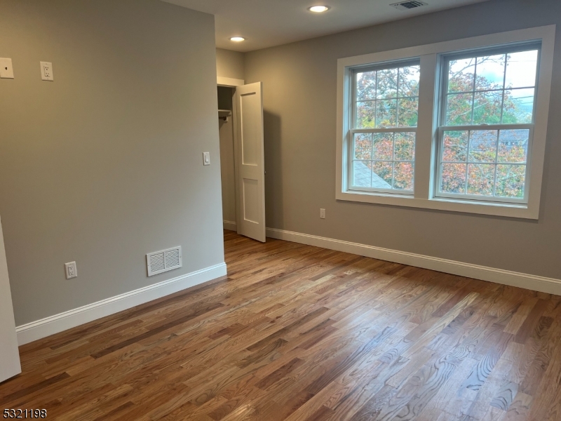 33 Morris Avenue Summit, NJ 07901 - Photo 15 of 28 an empty room with wooden floor and windows